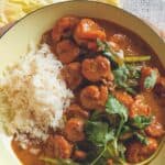 picture of prawn curry with a side of rice in a pot