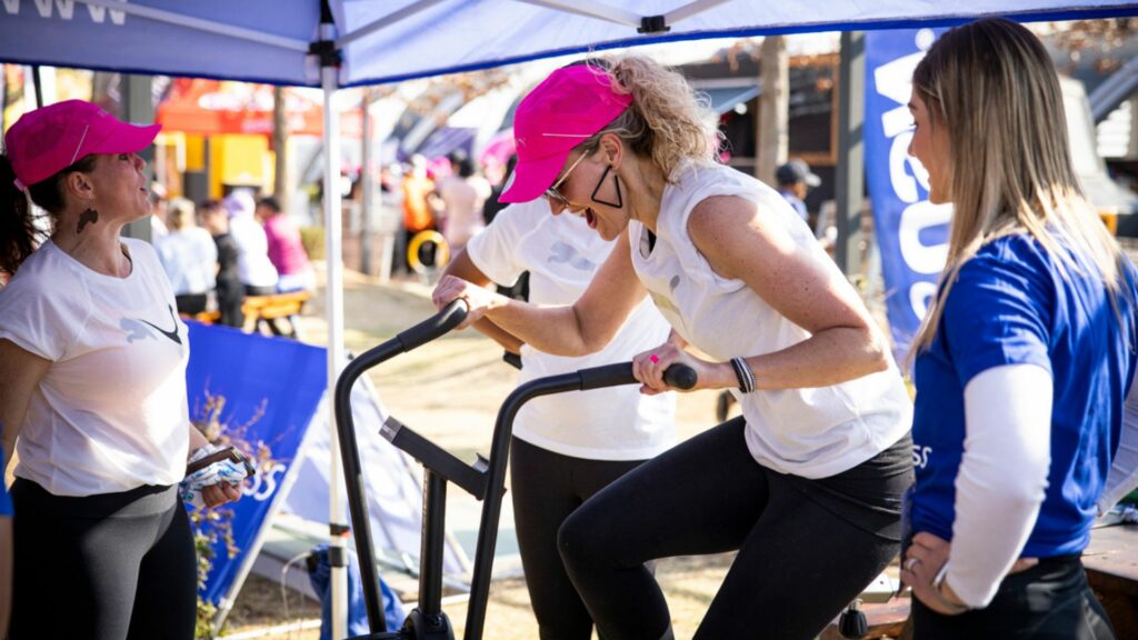 Planet Fitness woman biking at Fit Night Out Joburg