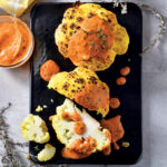 cauliflower recipe made and served on a black board with sauce