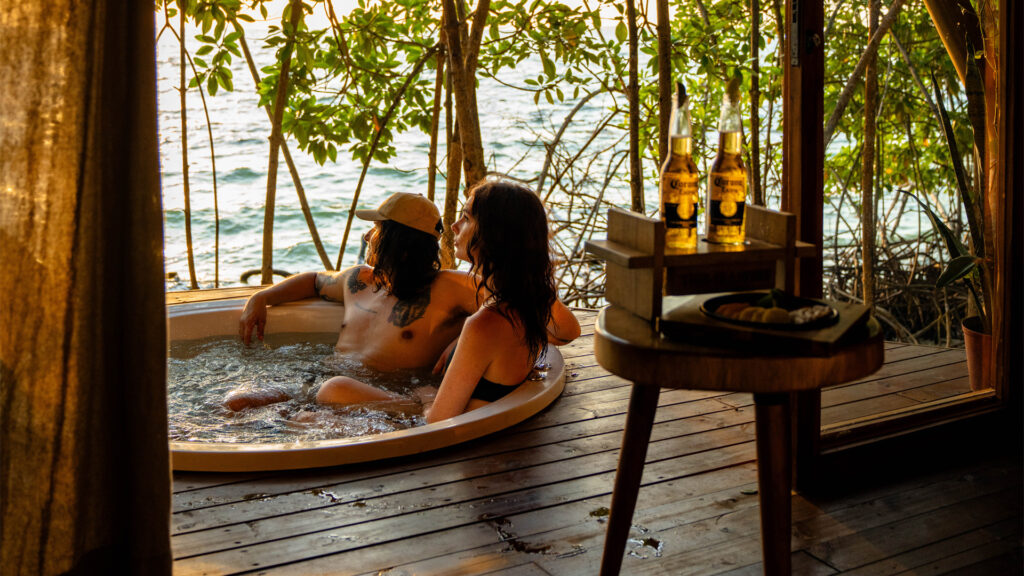 couple in a Jacuzzi at sunset on Corona Island