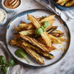 Baby Marrow Fries on plate with fresh basil