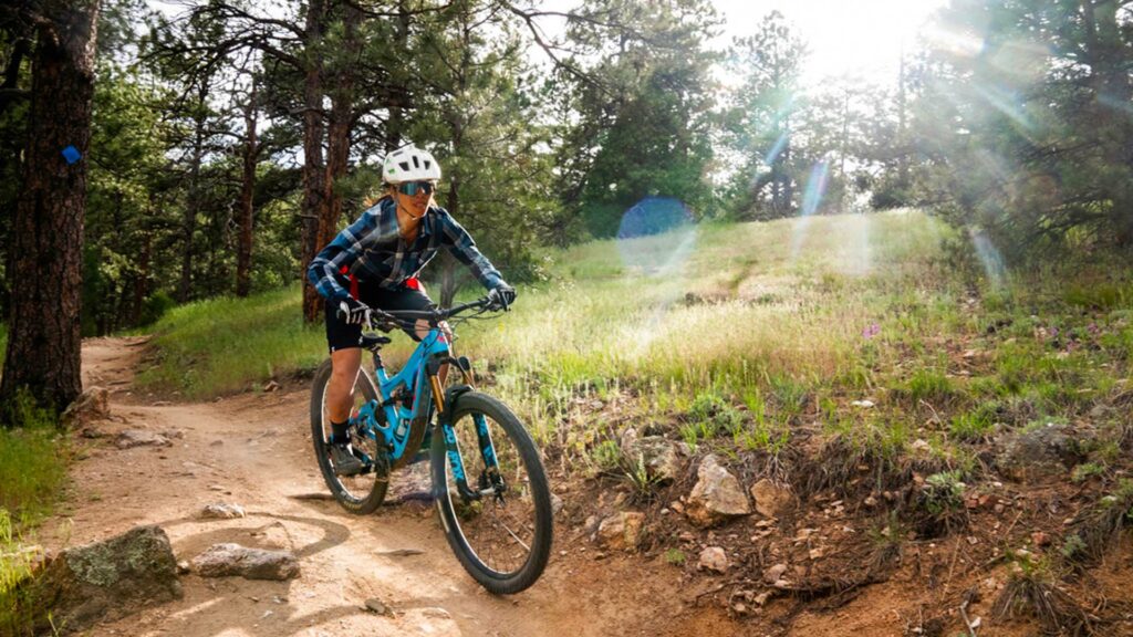 woman cycling off the beaten track with her mountain bike