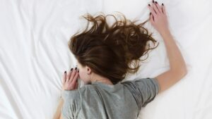 woman sleeping on a mattress after doing pressure mapping