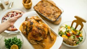 a plate of chicken being placed on a table of healthy sides with chicken variations