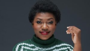 south african actress masutang rasekele smiling with her left hand up