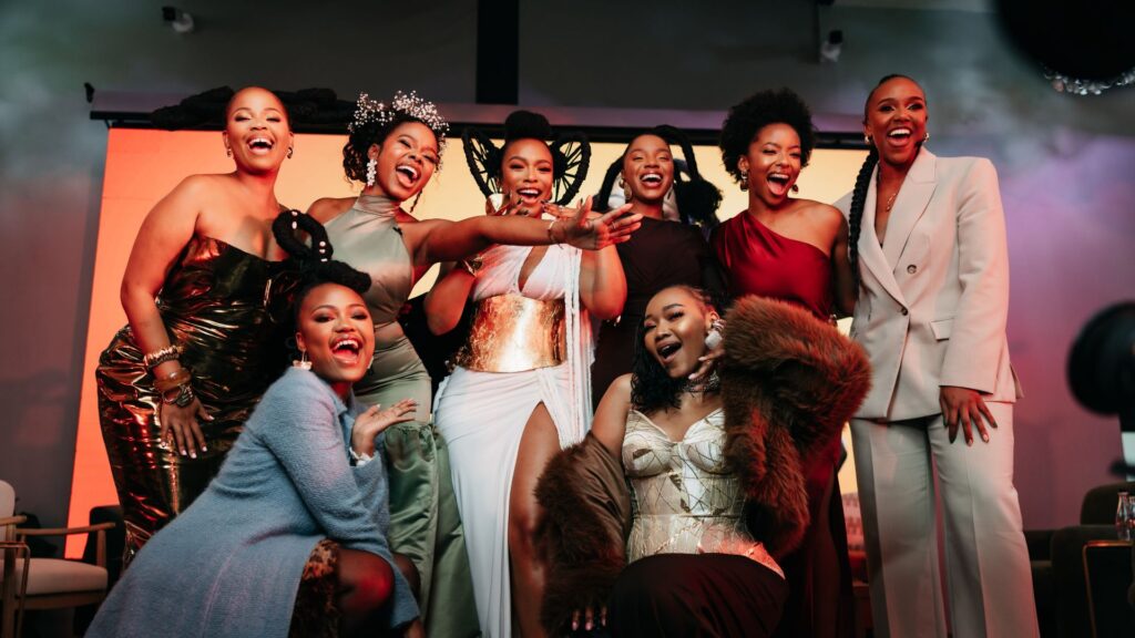 Nomzamo Mbatha surrounded by the Creme of Nature Hair Squad, made up of prominent South African influencers, along with the brand's manager Zandi Zinganto.