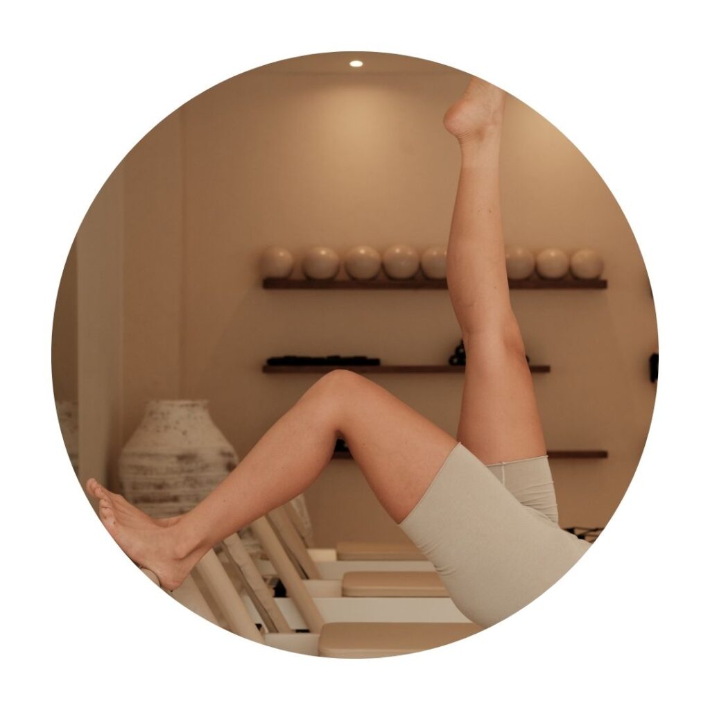 Woman's legs doing Pilates on the reformer