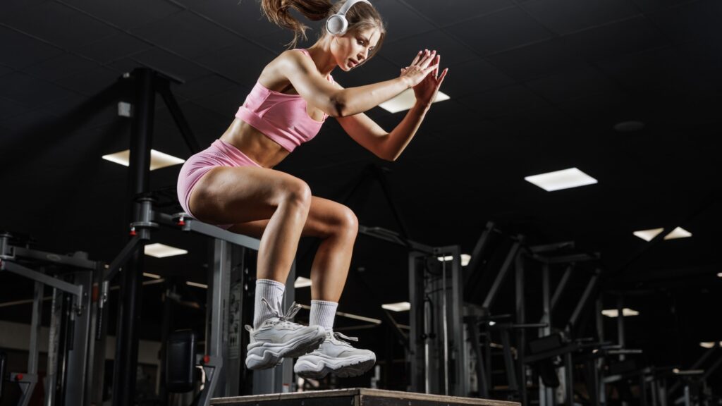 woman doing total-body strength workout box jump